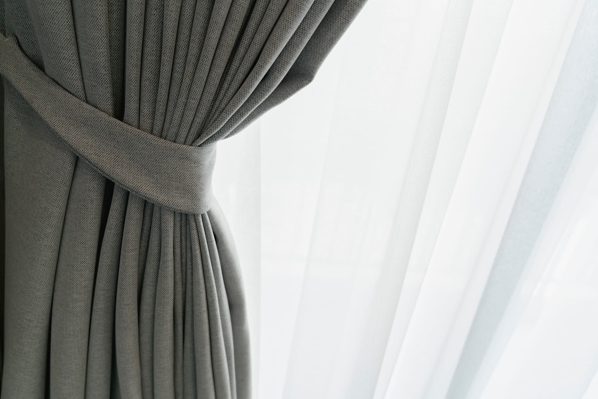 Drapery panel gathered at a tieback, sheer behind