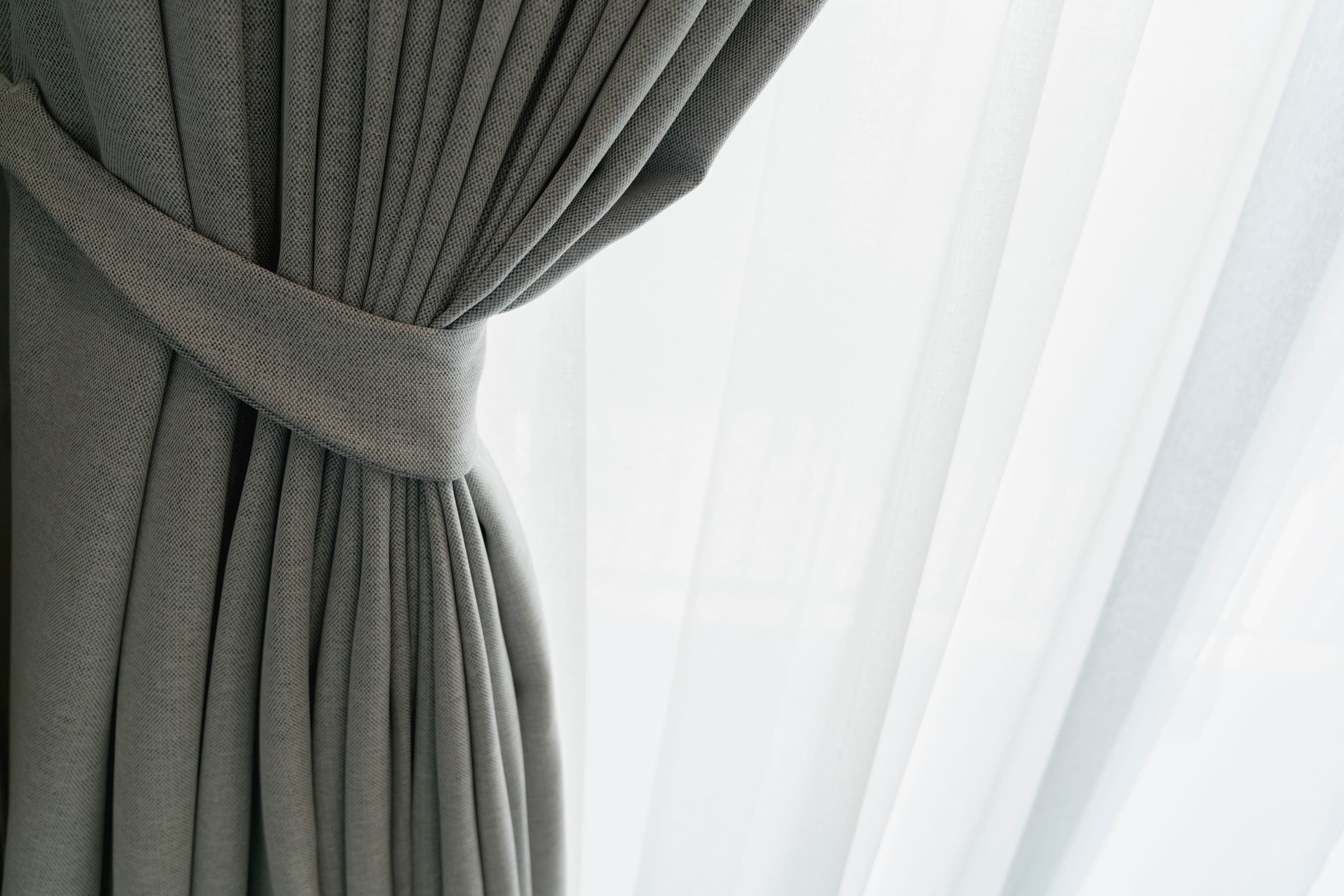 Drapery panel gathered at a tieback, sheer behind